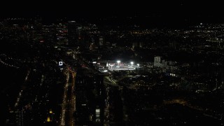 AX141_128 - 5.5K stock footage aerial video of a baseball game in progress, Fenway Park, Downtown Boston, Massachusetts, night