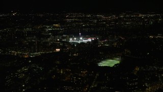 AX141_133 - 5.5K aerial stock footage flying away from a baseball game, Fenway Park, Boston, Massachusetts, night