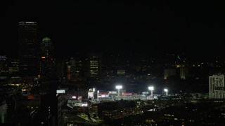 AX141_143 - 5.5K aerial stock footage flying by Fenway Park with a baseball game in progress, Boston, Massachusetts, night