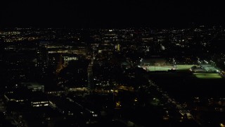 AX141_144 - 5.5K aerial stock footage flying by Massachusetts Institute of Technology, Cambridge, Massachusetts, night