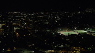 AX141_146 - 5.5K aerial stock footage flying by sports fields, Massachusetts Institute of Technology, Cambridge, Massachusetts, night