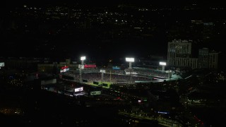 AX141_181E - 5.5K aerial stock footage orbiting city streets, baseball game at Fenway Park, Boston, Massachusetts, night