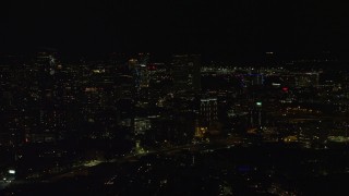 AX141_188 - 5.5K stock footage aerial video flying by skyscrapers, Downtown Boston, Massachusetts, night