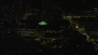 AX141_189E - 5.5K aerial stock footage flying by Copley Place shopping mall, Downtown Boston, Massachusetts, night