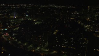 AX141_194E - 5.5K aerial stock footage flying by city streets, office buildings, West End, Downtown Boston, Massachusetts, night