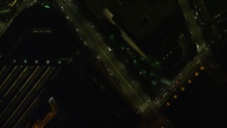 AX141_209E - 5.5K aerial stock footage of a bird's eye view over small bridge, city street, Downtown Boston, Massachusetts, night