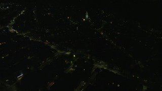 AX141_219E - 5.5K aerial stock footage flying by Broadway, Dorchester Heights Monument, South Boston, Massachusetts, night