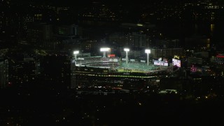 AX141_245 - 5.5K aerial stock footage orbiting away from a baseball game at night at Fenway Park, Boston, Massachusetts