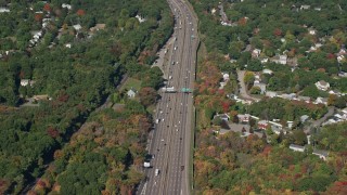 AX142_005E - 5.5K aerial stock footage flying by Interstate 93, homes, trees, autumn, Westwood, Massachusetts
