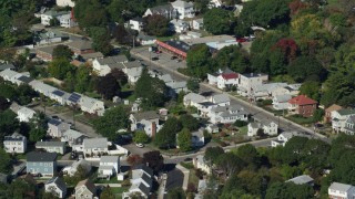 AX142_009 - 5.5K aerial stock footage flying over small town, homes, pond, trees, autumn, Hyde Park, Massachusetts