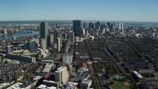 AX142_019 - 5.5K aerial stock footage flying over buildings in autumn, approaching Downtown Boston, Massachusetts