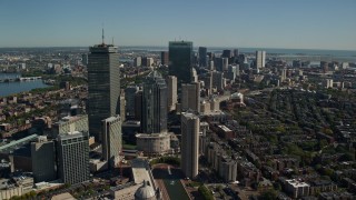 AX142_019E - 5.5K aerial stock footage flying over buildings in autumn, approaching Downtown Boston, Massachusetts