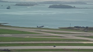 AX142_031E - 5.5K aerial stock footage tracking plane taking off, Logan International Airport, Boston, Massachusetts