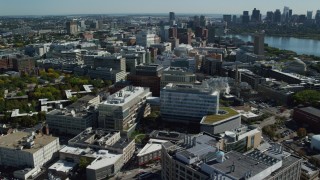 AX142_046 - 5.5K aerial stock footage flying by MIT, revealing Downtown Boston skyline, Cambridge, Massachusetts