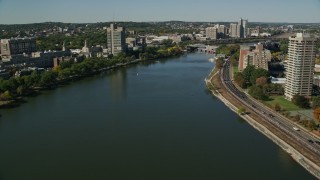 AX142_057 - 5.5K aerial stock footage flying over Charles River, by office buildings, Boston, Massachusetts