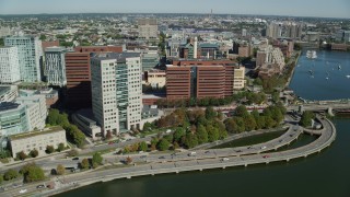 AX142_072 - 5.5K stock footage aerial video flying by commuter train, office buildings, Cambridge, Massachusetts