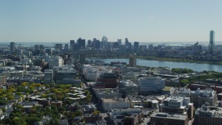 AX142_125 - 5.5K stock footage aerial video flying over MIT, by the skyline, Downtown Boston, Massachusetts