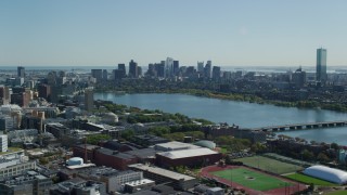 AX142_126 - 5.5K stock footage aerial video flying by skyline from over MIT, Downtown Boston, Massachusetts