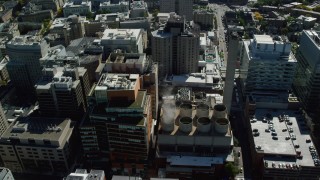 AX142_138 - 5.5K stock footage aerial video of Longwood Medical Area, tilt down over power plant, Boston, Massachusetts