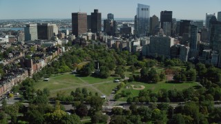 AX142_166 - 5.5K stock footage aerial video flying over Boston Common, approaching Downtown Boston, Massachusetts
