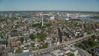 AX142_178 - 5.5K stock footage aerial video flying by row houses, Bunker Hill Monument, Charlestown, Massachusetts