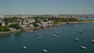 AX142_213E - 5.5K aerial stock footage flying by piers, anchored boats, South Boston, Massachusetts