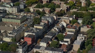AX142_229 - 5.5K aerial stock footage flying by row houses, streets, South Boston, Massachusetts
