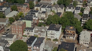 AX142_235 - 5.5K aerial stock footage flying by apartment buildings, quiet streets, South Boston, Massachusetts