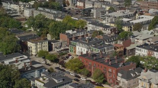 AX142_236 - 5.5K aerial stock footage flying by row houses, tilt down, South Boston, Massachusetts