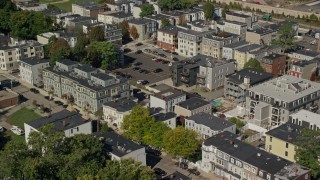 AX142_237 - 5.5K aerial stock footage flying by apartment buildings, tilt down, South Boston, Massachusetts