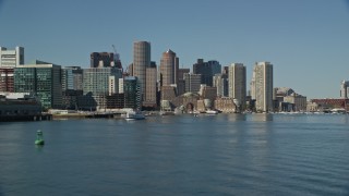 AX142_291E - 5.5K aerial stock footage flying low by Rowes Wharf, approaching Downtown Boston, Massachusetts