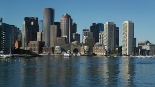 AX142_294 - 5.5K aerial stock footage flying low by Rowes Wharf and the skyline, Downtown Boston, Massachusetts