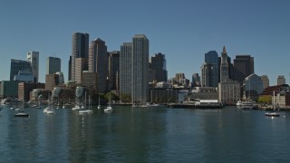 AX142_295E - 5.5K aerial stock footage flying low by Rowes Wharf and the skyline, Downtown Boston, Massachusetts