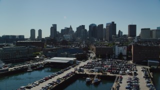 AX142_298 - 5.5K aerial stock footage flying by waterfront property, wharves, piers, Downtown Boston, Massachusetts