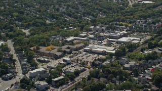 AX142_317E - 5.5K aerial stock footage flying by large strip mall, neighborhoods, Hyde Park, Massachusetts