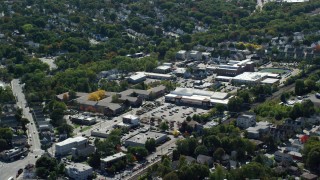 AX142_318 - 5.5K aerial stock footage flying by large strip mall, neighborhoods, Hyde Park, Massachusetts