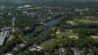 AX142_319 - 5.5K aerial stock footage flying over small town neighborhoods, approach Mill Pond, Hyde Park, Massachusetts