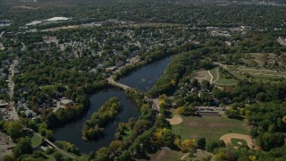 AX142_319E - 5.5K aerial stock footage flying over small town neighborhoods, Mill Pond, Hyde Park, Massachusetts