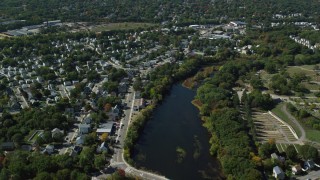 AX142_320 - 5.5K aerial stock footage flying over small town neighborhoods, Mill Pond, Hyde Park, Massachusetts