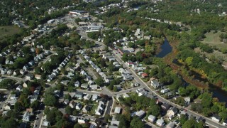 AX142_321 - 5.5K aerial stock footage flying by small town neighborhoods, Mill Pond, Hyde Park, Massachusetts