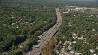 AX142_323 - 5.5K aerial stock footage flying over neighborhoods, Interstate 93, autumn, Westwood, Massachusetts