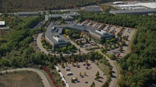 AX142_324 - 5.5K aerial stock footage approaching, flying over office building, tilt down, autumn, Westwood, Massachusetts