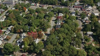 AX143_004E - 5.5K aerial stock footage flying over small town neighborhoods, trees, autumn, Randolph, Massachusetts