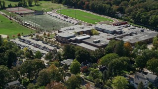 AX143_020 - 5.5K aerial stock footage flying away from Hingham High School, autumn, Hingham, Massachusetts