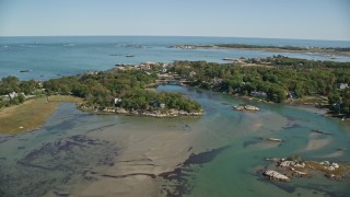 AX143_026E - 5.5K aerial stock footage fly over a small town by a lake, approach upscale oceanfront homes, Cohasset, Massachusetts