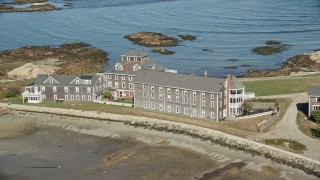 AX143_030 - 5.5K aerial stock footage flying by isolated upscale oceanfront home, Scituate, Massachusetts
