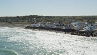 AX143_033 - 5.5K aerial stock footage flying by oceanfront homes, pan right, Scituate, Massachusetts