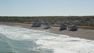 AX143_034 - 5.5K aerial stock footage flying by oceanfront homes, waves crashing on beach, Scituate, Massachusetts