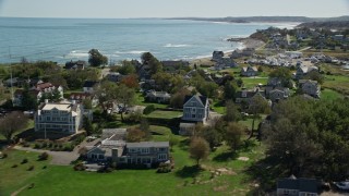AX143_042E - 5.5K aerial stock footage flying by rocky beach, oceanfront homes, Scituate, Massachusetts