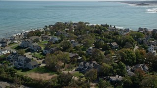 AX143_044 - 5.5K aerial stock footage flying by upscale oceanfront homes, Scituate, Massachusetts